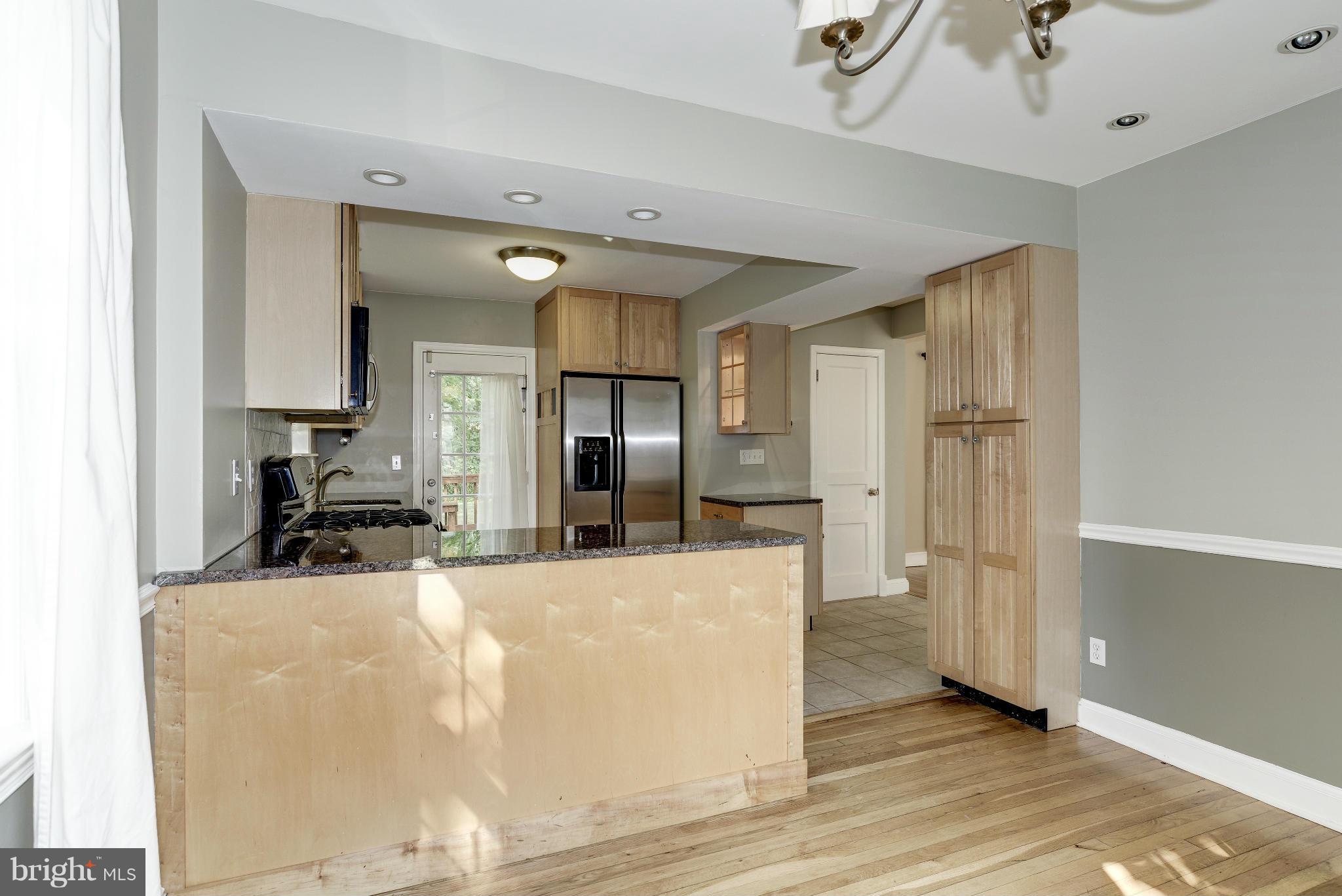 9006 Walden Road Silver Spring, MD 20901 - Photo 11 of 30 a large kitchen with a sink and stainless steel appliances