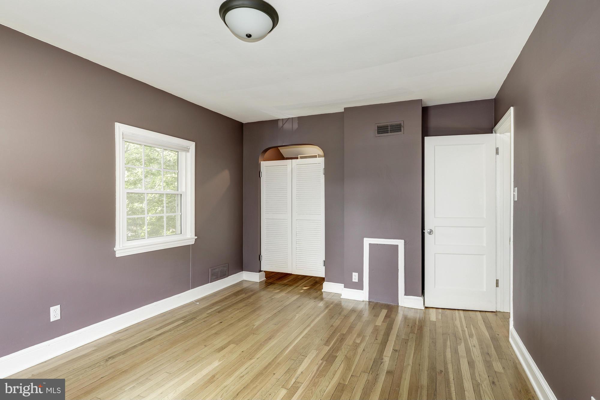 9006 Walden Road Silver Spring, MD 20901 - Photo 17 of 30 a view of an empty room with wooden floor and a window