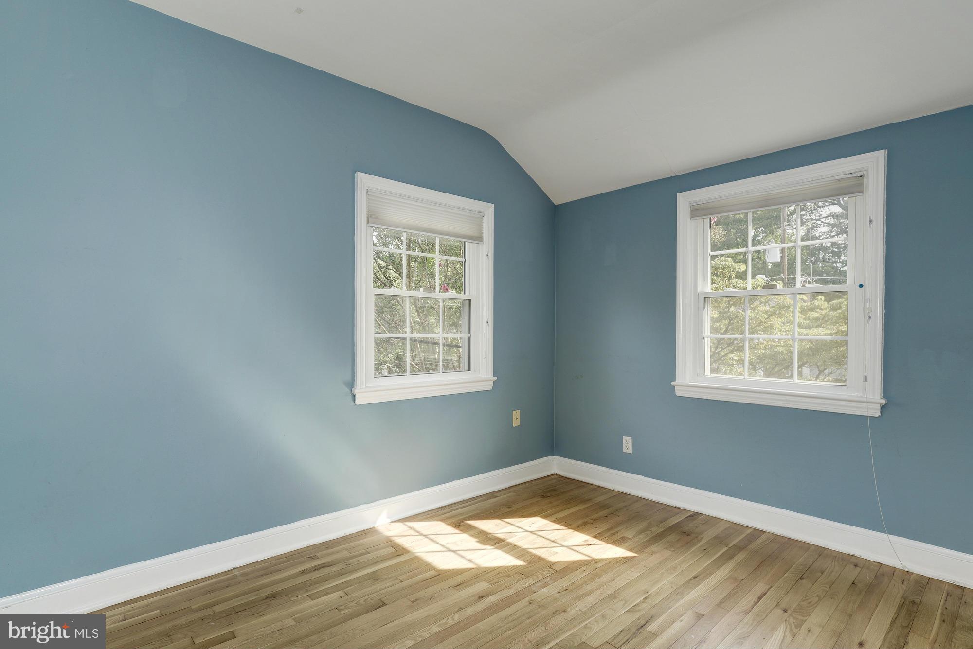 9006 Walden Road Silver Spring, MD 20901 - Photo 20 of 30 a view of empty room with wooden floor and a window