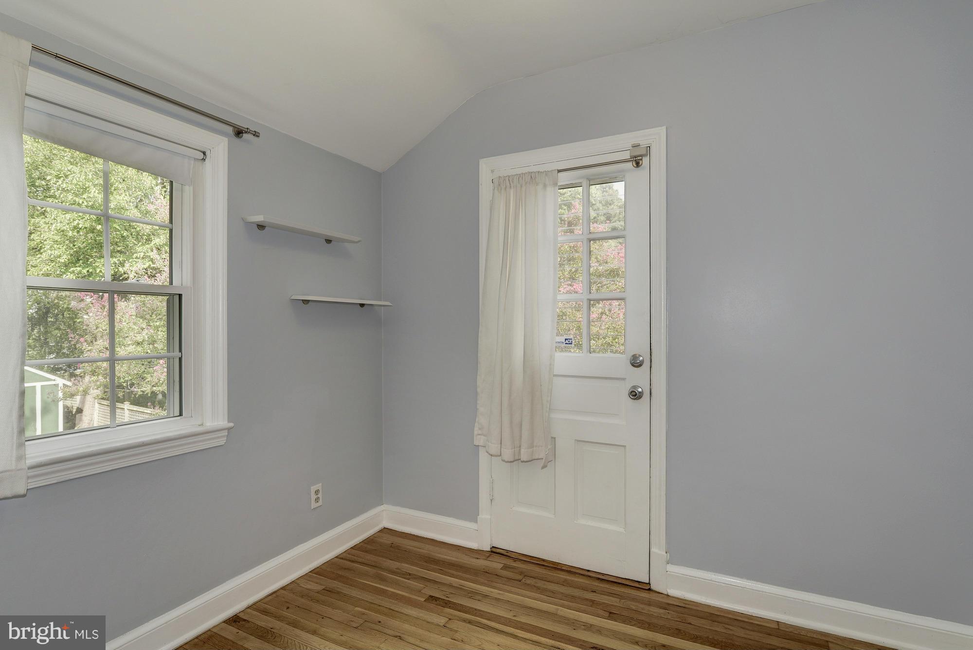 9006 Walden Road Silver Spring, MD 20901 - Photo 22 of 30 a view of an empty room with wooden floor and a window