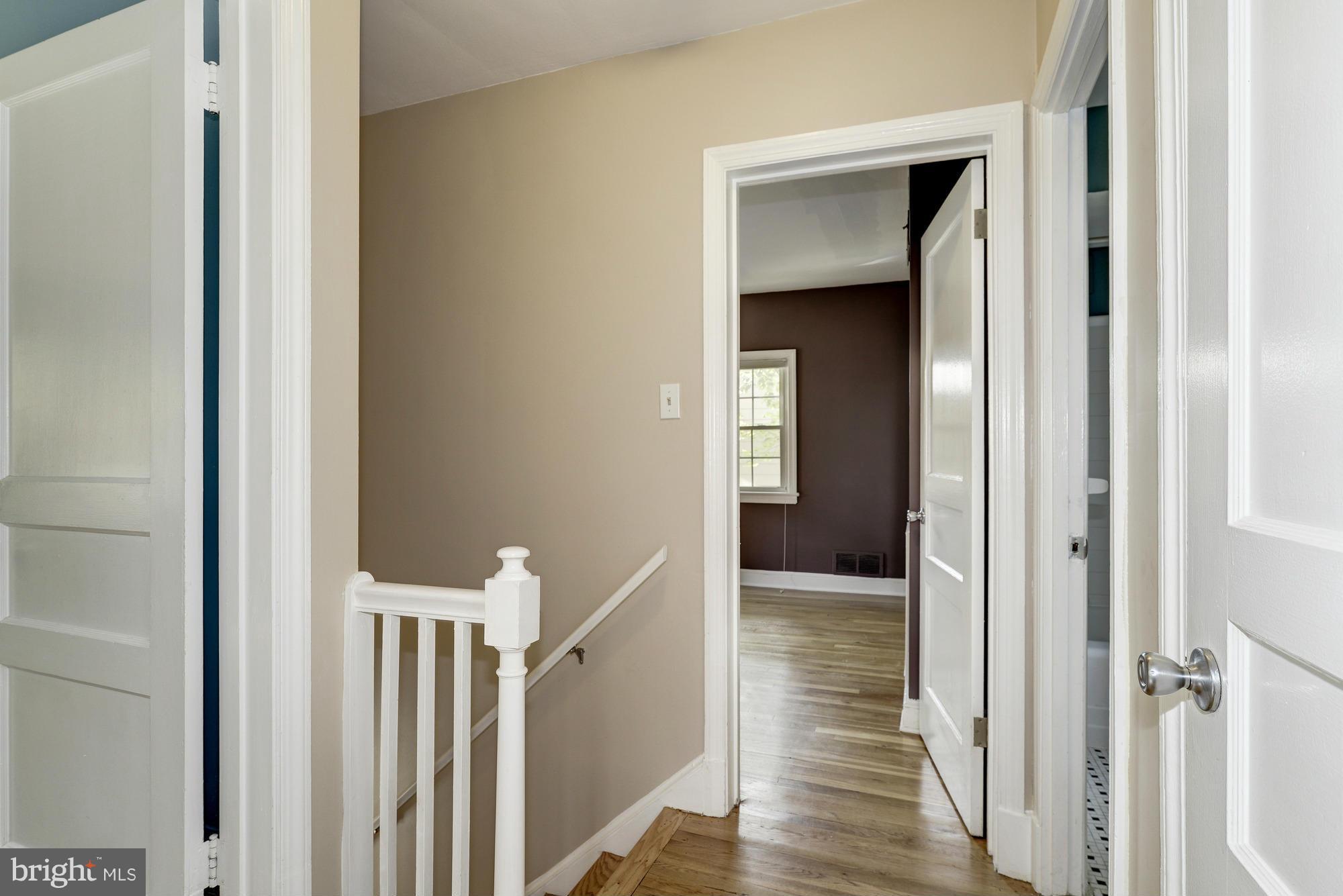 9006 Walden Road Silver Spring, MD 20901 - Photo 23 of 30 a view of a hallway with wooden floor and entryway