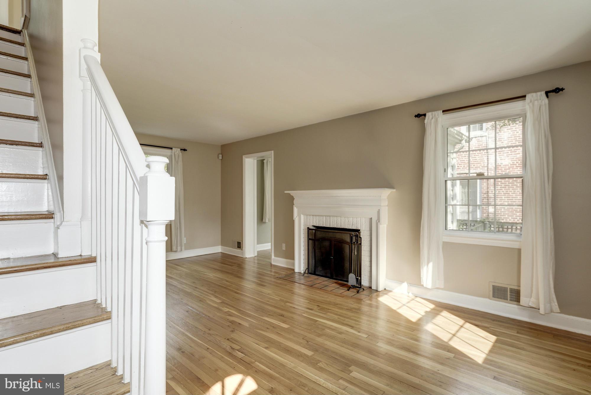 9006 Walden Road Silver Spring, MD 20901 - Photo 4 of 30 a view of an empty room with wooden floor and a window