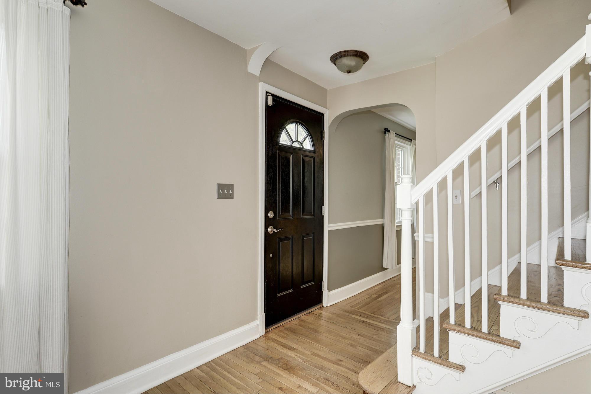 9006 Walden Road Silver Spring, MD 20901 - Photo 5 of 30 a view of a hallway with wooden floor and staircase