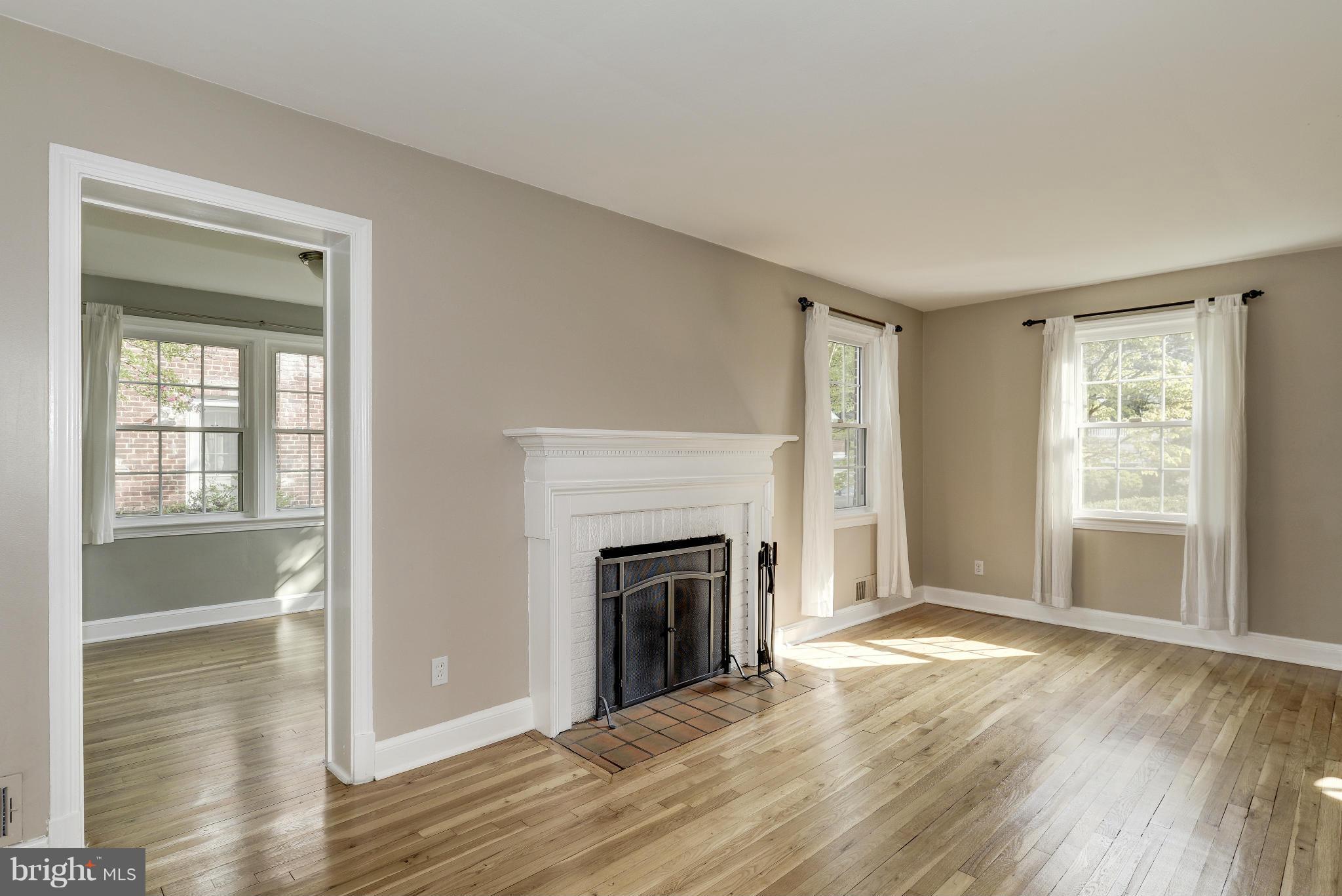 9006 Walden Road Silver Spring, MD 20901 - Photo 6 of 30 a view of an empty room with window and fire place