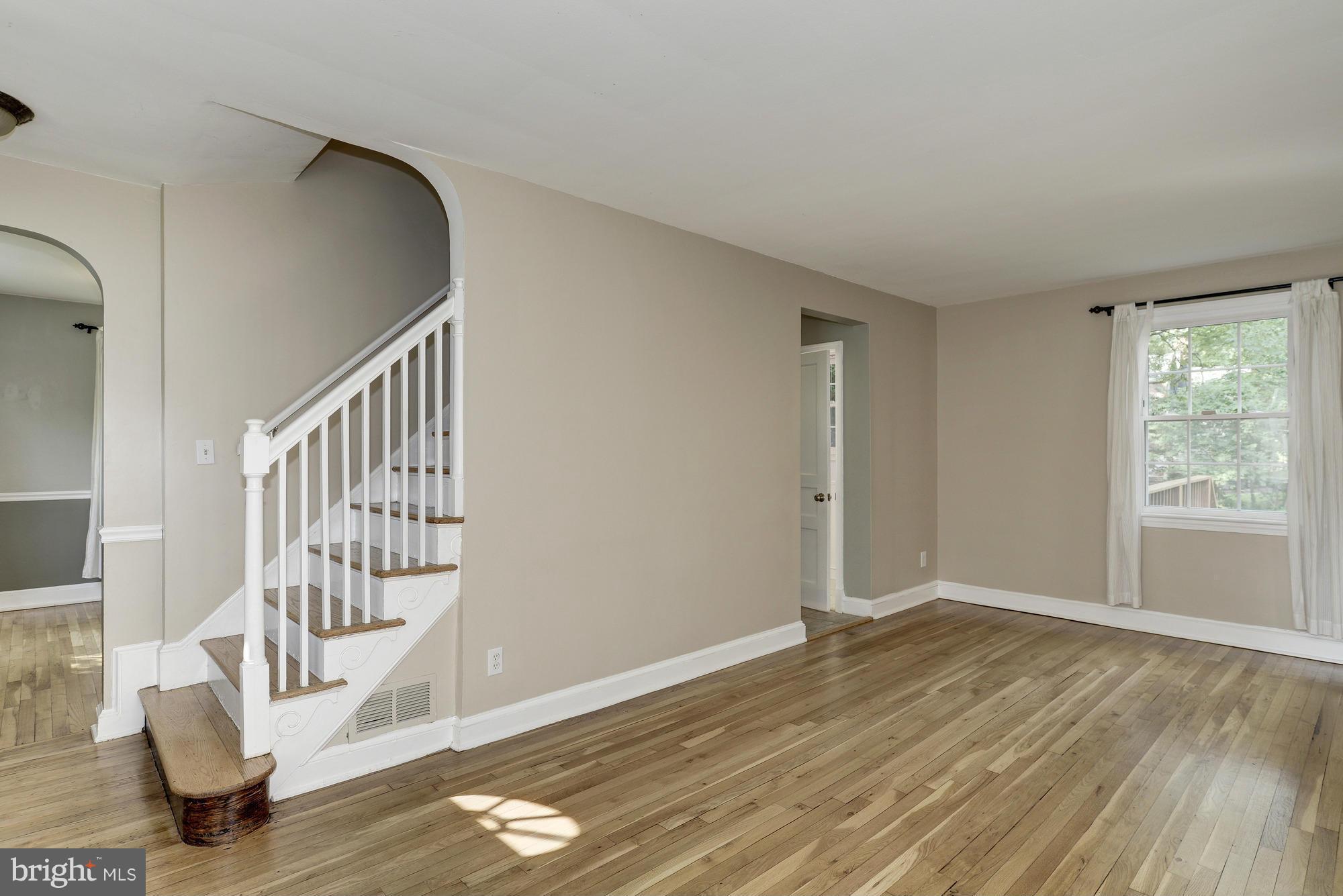 9006 Walden Road Silver Spring, MD 20901 - Photo 7 of 30 a view of an empty room with wooden floor and windows