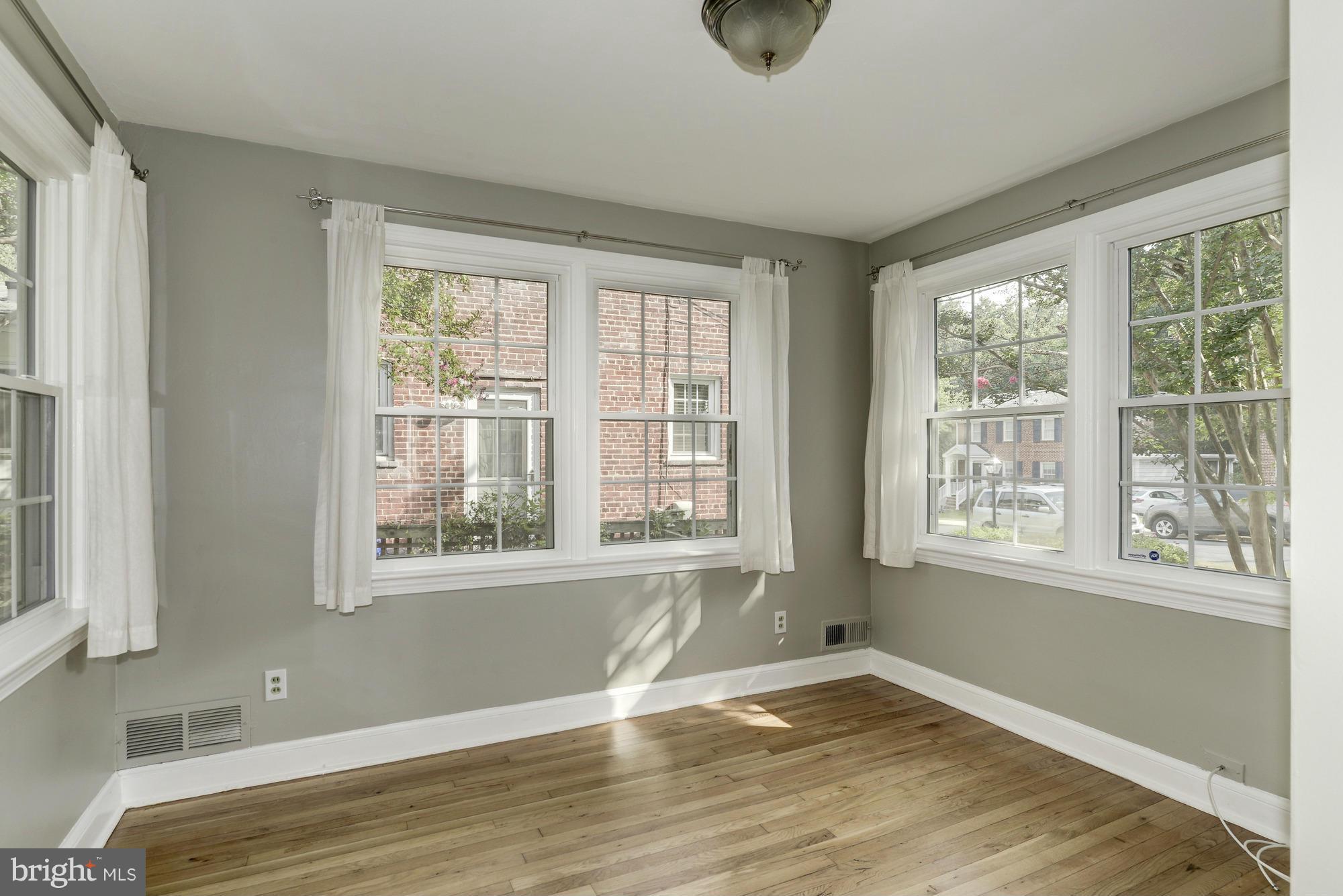 9006 Walden Road Silver Spring, MD 20901 - Photo 8 of 30 a view of an empty room with wooden floor and a window