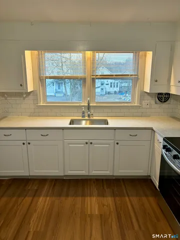 a kitchen with sink cabinets and window