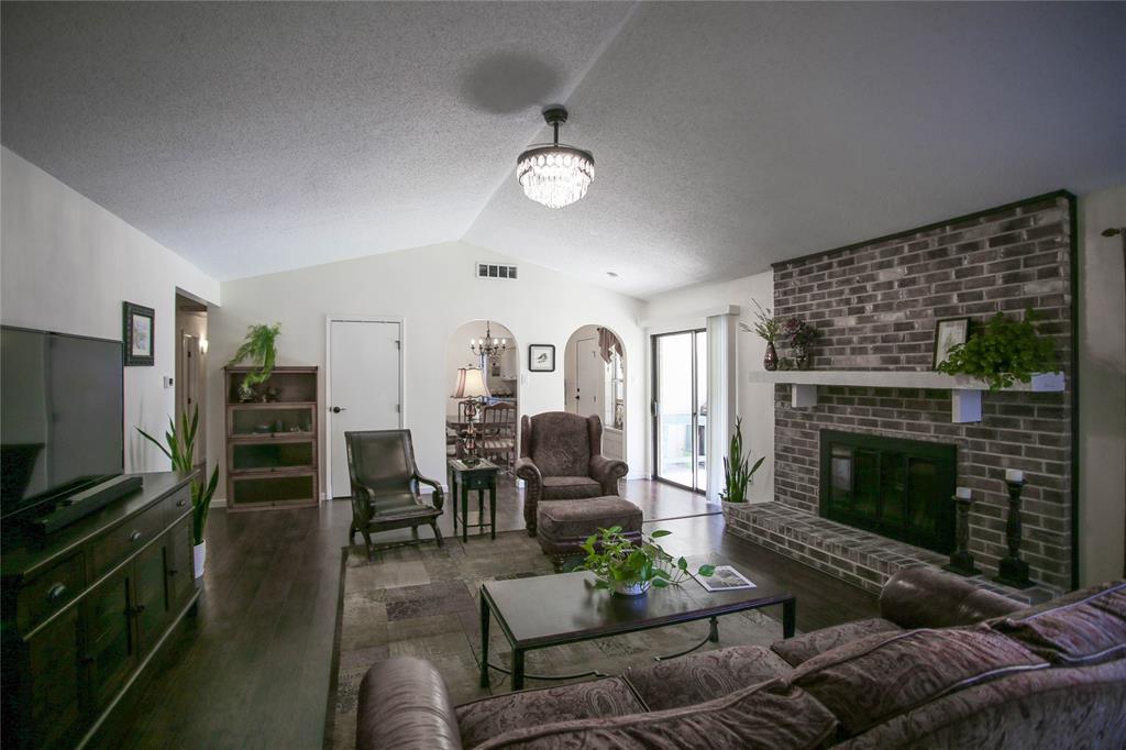 1720 Crystal Way Plano, TX 75074 - Photo 8 of 32 a living room with furniture a fireplace and a flat screen tv