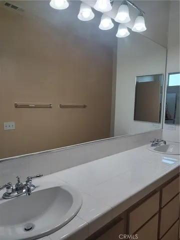 a front view of a house with yard and plants