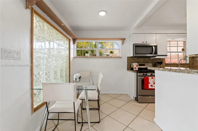 a dining room with furniture and windows