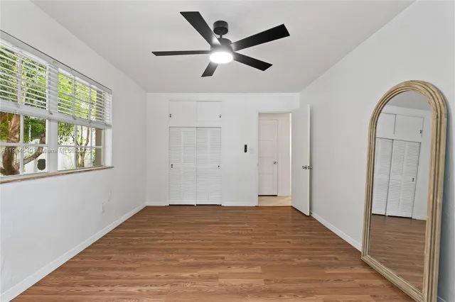 a view of a patio with couches table and chairs and potted plants
