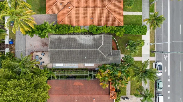 a view of a house with backyard garden and sitting area