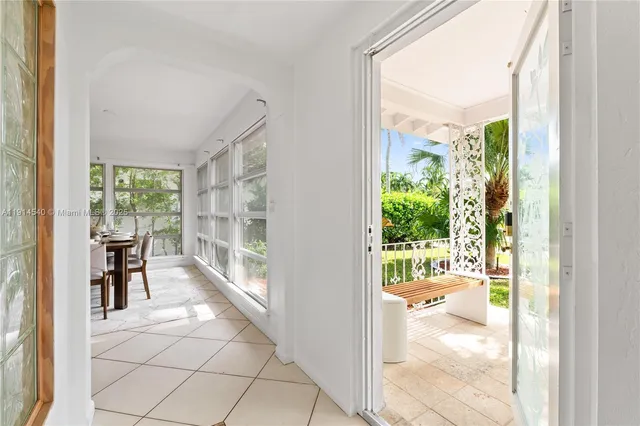 a view of a room with a large window and dining room