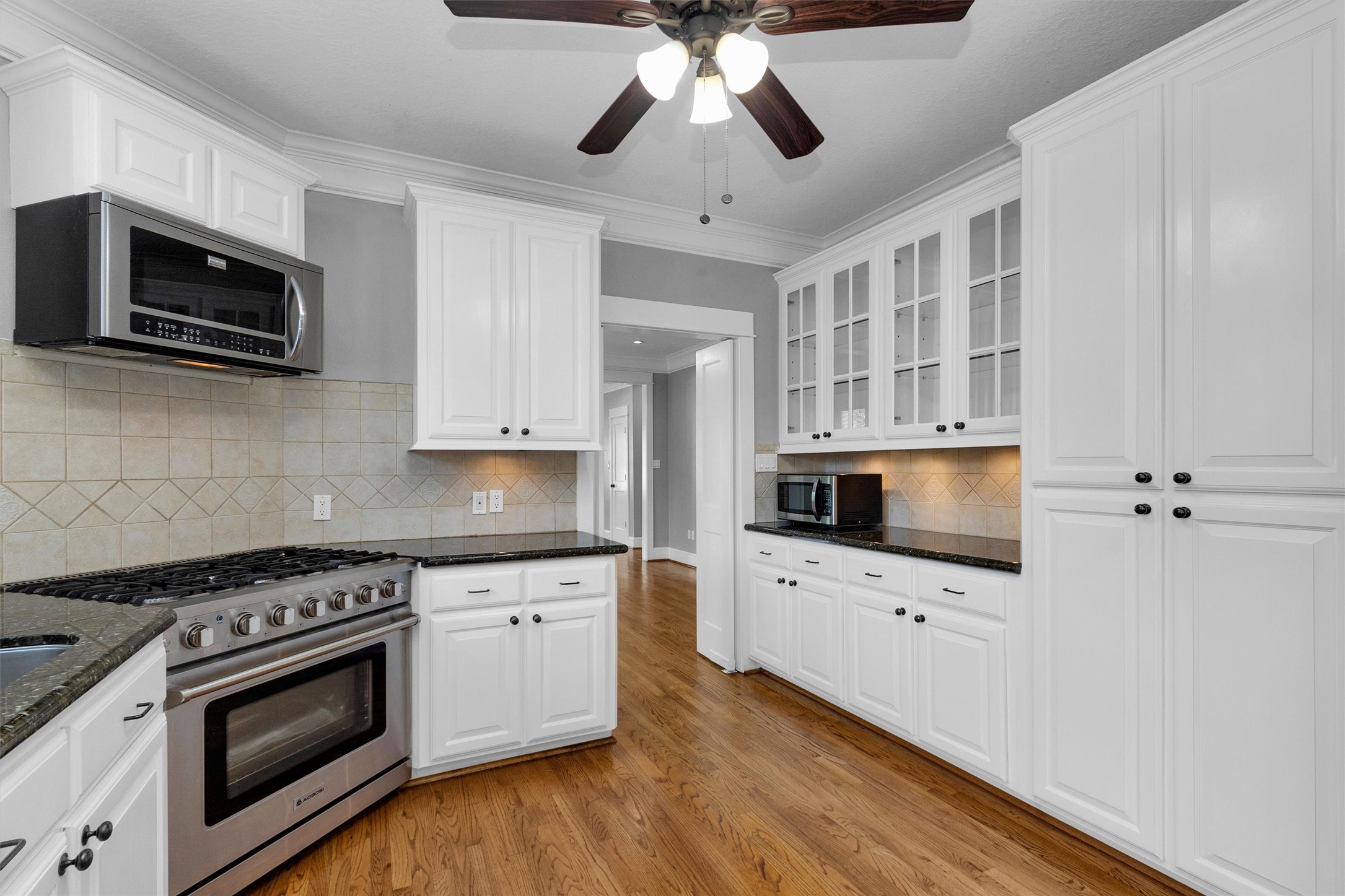 304 Vincent Street Houston, TX 77009 - Photo 12 of 36 a kitchen with stainless steel appliances a stove microwave and sink