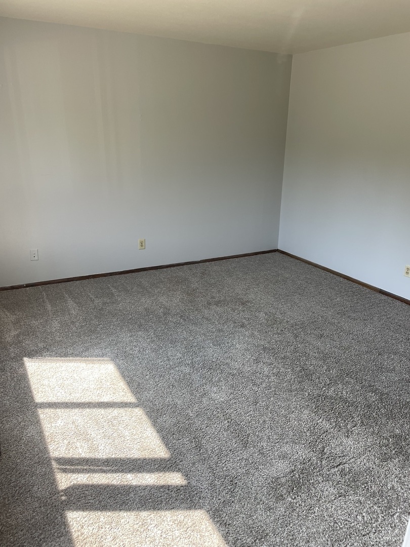 348 Irene Avenue, Unit 2 Rochelle, IL 61068 - Photo 2 of 5 a view of an empty room and kitchen