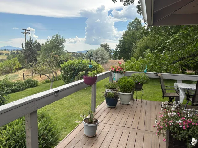 a view of a chairs and table on the wooden deck