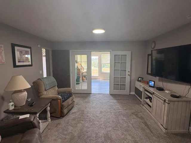a white toilet sitting next to a bathroom sink and a mirror