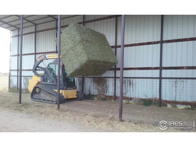 a living room with furniture and a kitchen view