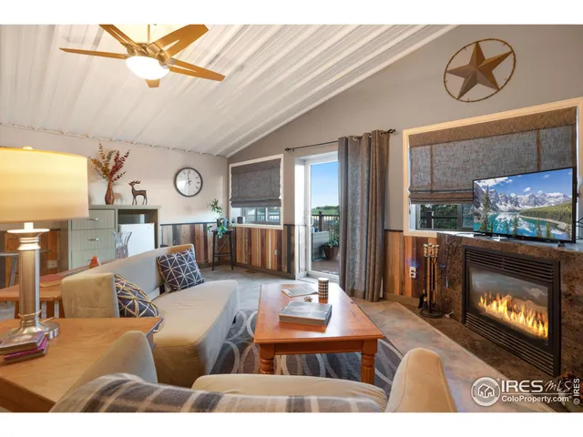 a view of a balcony with furniture and wooden floor