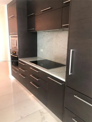 a kitchen with a stove and a refrigerator