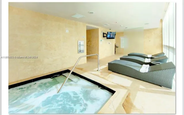 a view of hallway with furniture and a rug