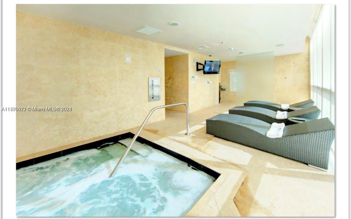 900 Biscayne Boulevard, Unit 4904 Miami, FL 33132 - Photo 22 of 29 a kitchen with a sink and a refrigerator