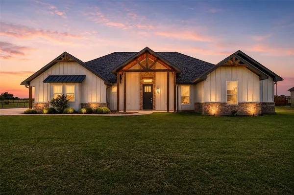 a front view of house with yard and green space