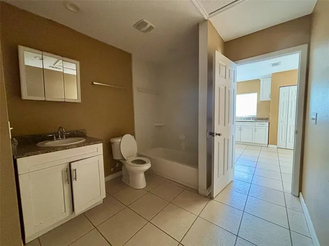 a bathroom with a sink a toilet and a shower