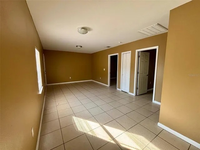 a view of a livingroom with an empty space and a window