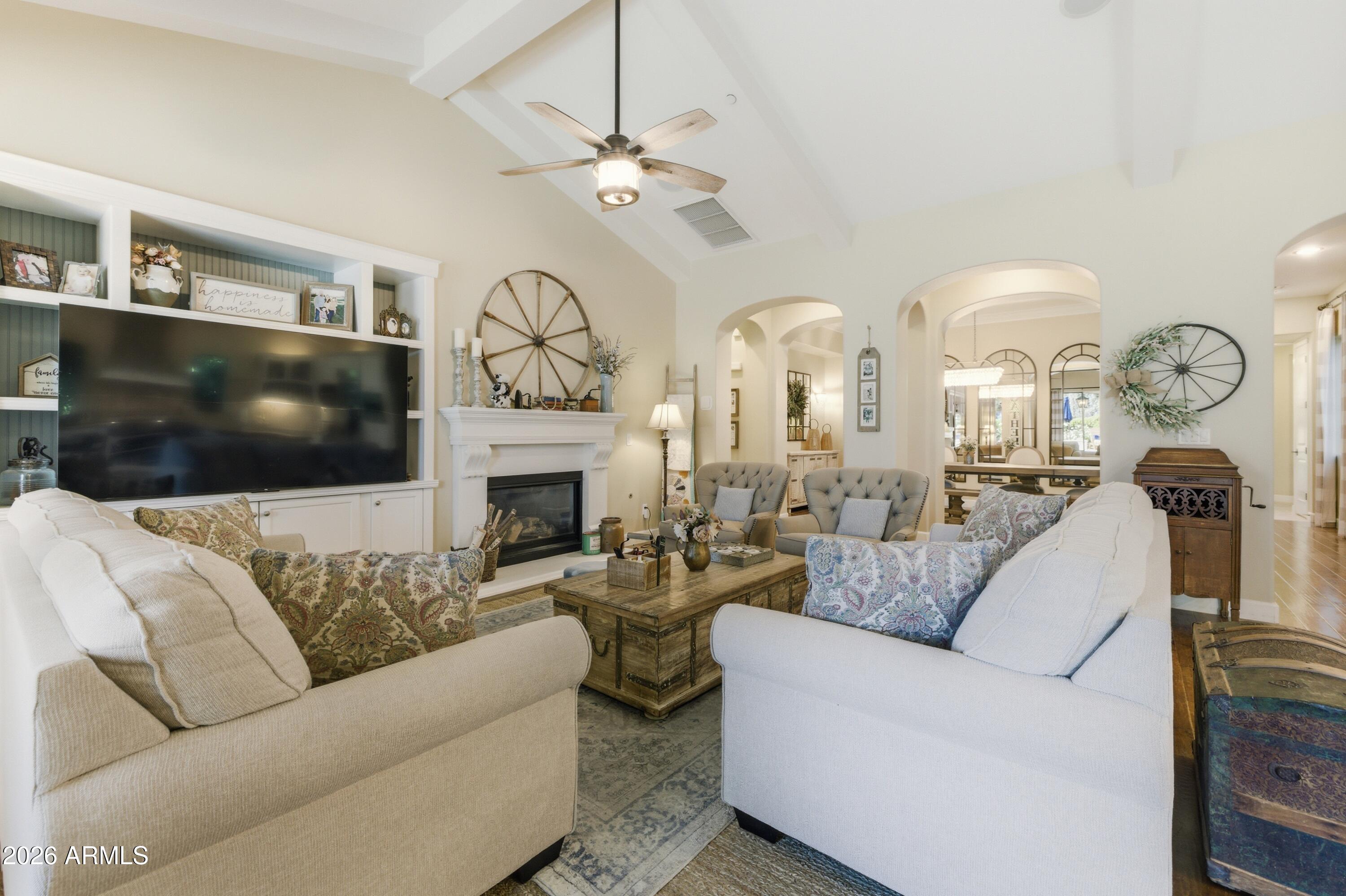 14474 West Coronado Road Goodyear, AZ 85395 - Photo 12 of 74 a living room with fireplace furniture and a flat screen tv