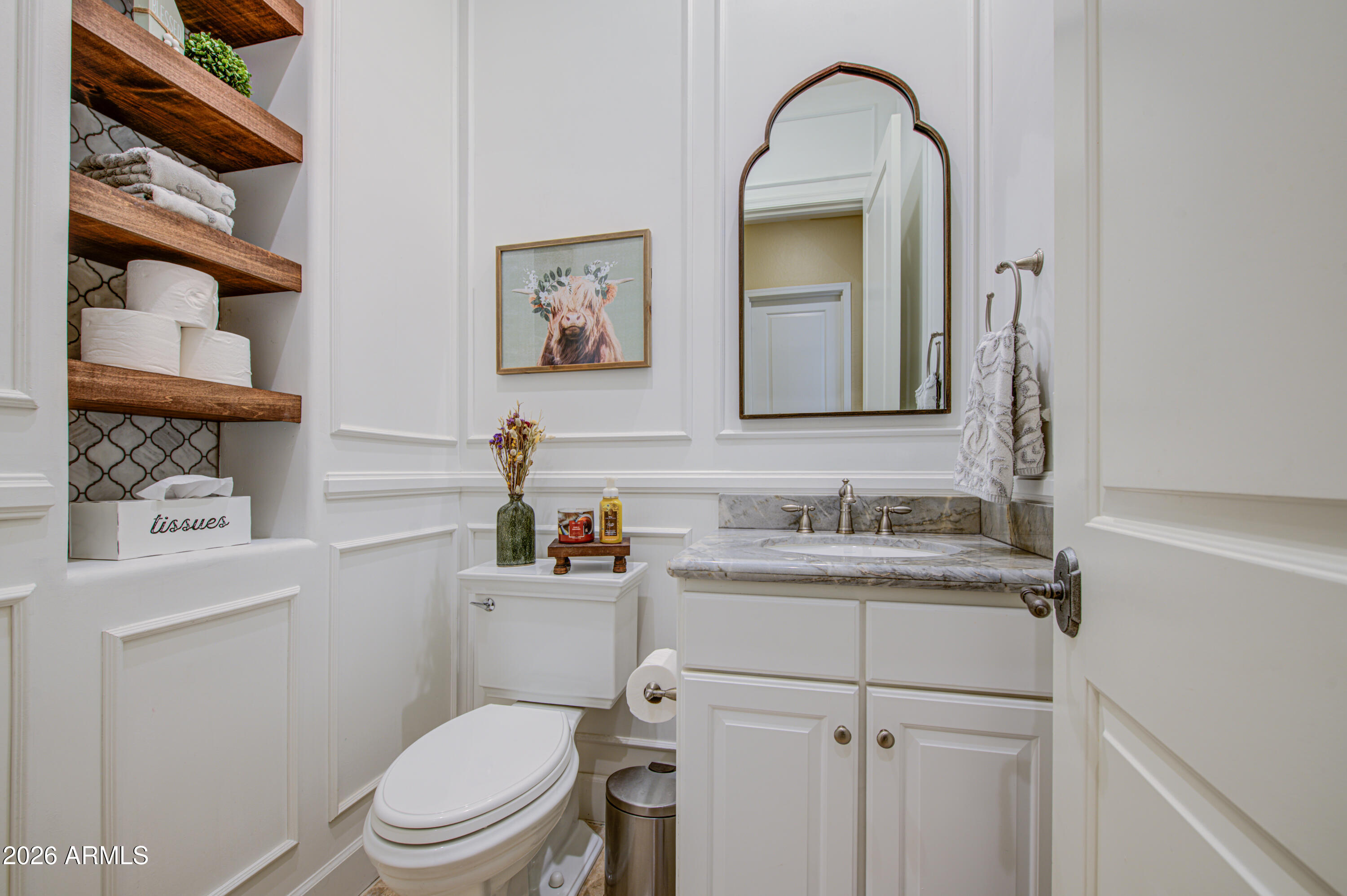 14474 West Coronado Road Goodyear, AZ 85395 - Photo 29 of 74 a bathroom with a toilet sink vanity and mirror