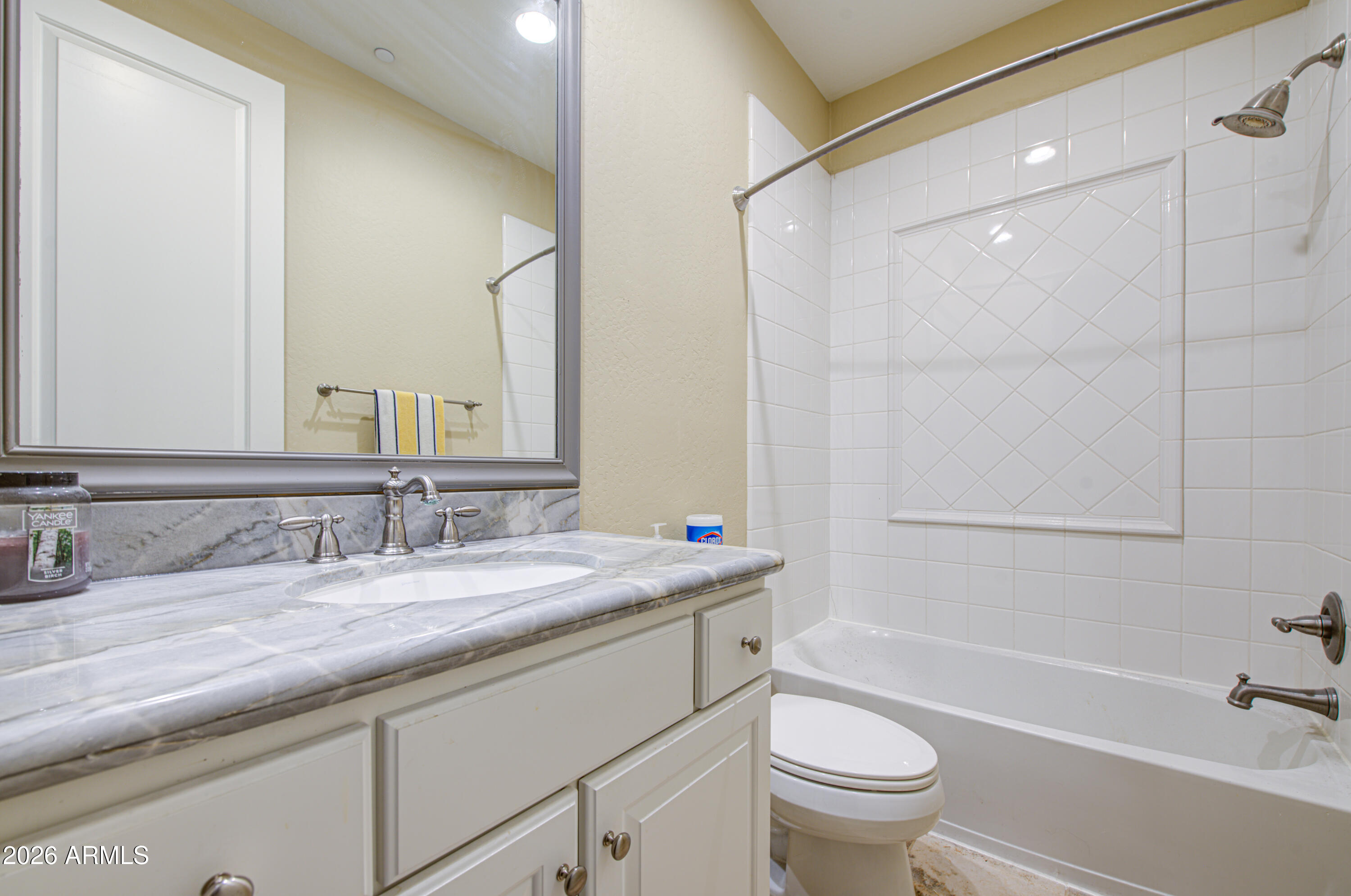 14474 West Coronado Road Goodyear, AZ 85395 - Photo 45 of 74 a bathroom with a granite countertop sink a toilet and a bathtub