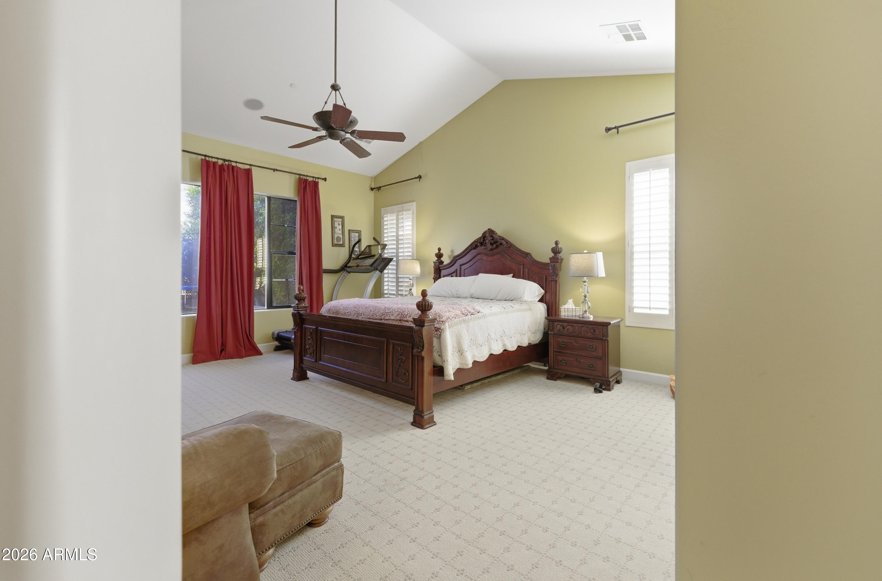 14474 West Coronado Road Goodyear, AZ 85395 - Photo 47 of 74 a spacious bedroom with a bed and a chandelier