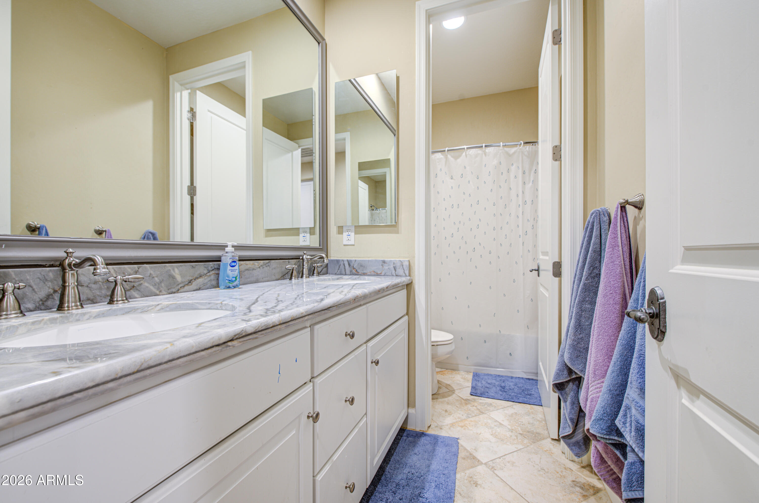 14474 West Coronado Road Goodyear, AZ 85395 - Photo 57 of 74 a bathroom with a granite countertop sink and a mirror