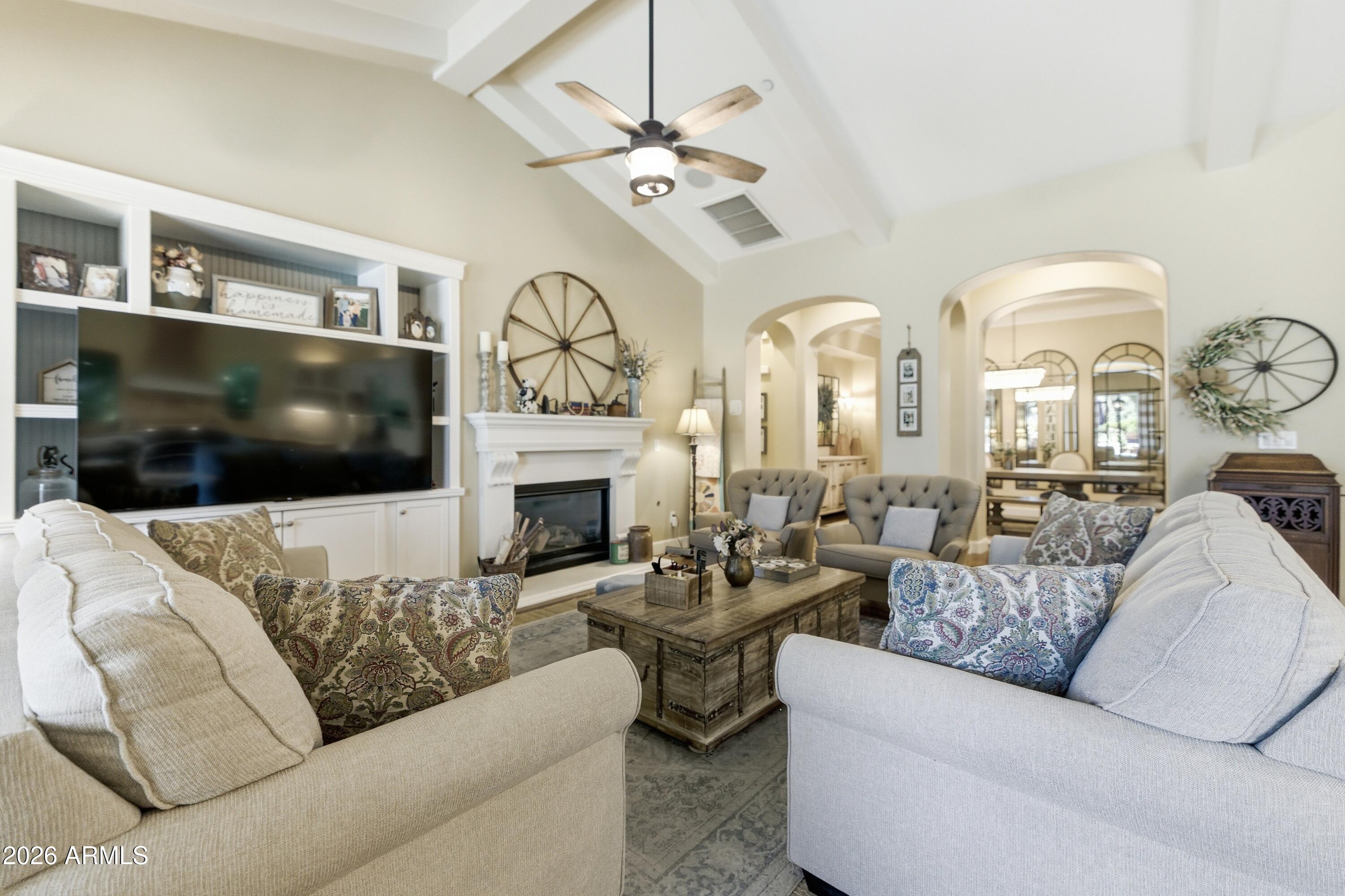 14474 West Coronado Road Goodyear, AZ 85395 - Photo 67 of 74 a living room with furniture a flat screen tv and a fireplace