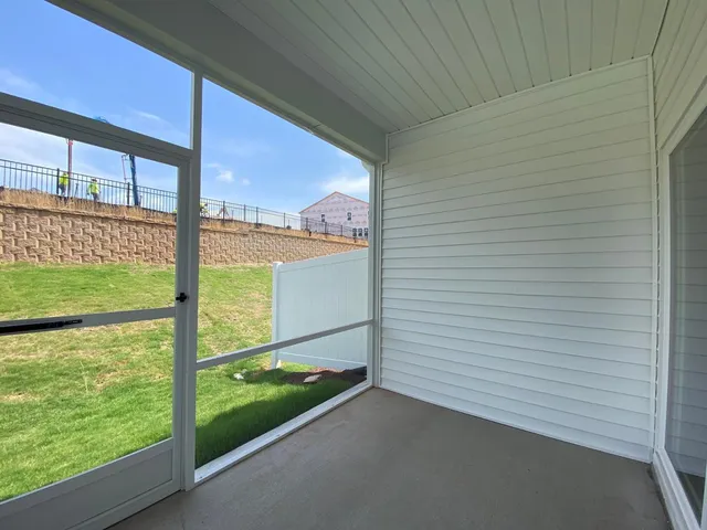a view of staircase with wooden floor and white walls