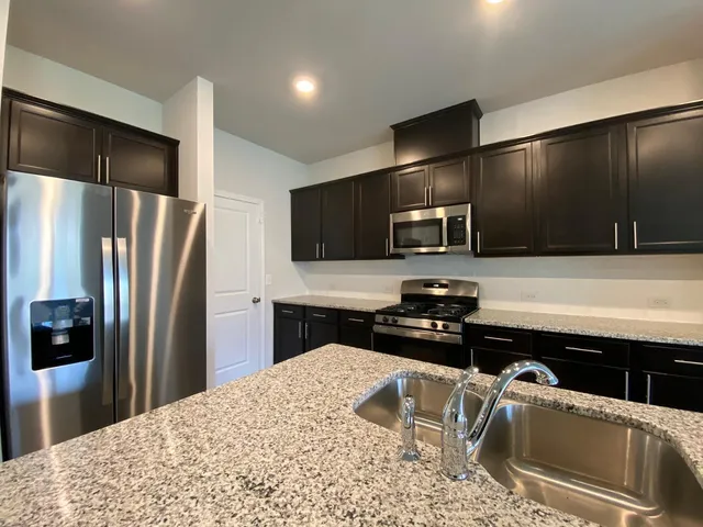 a view of a hallway with wooden floor and closet