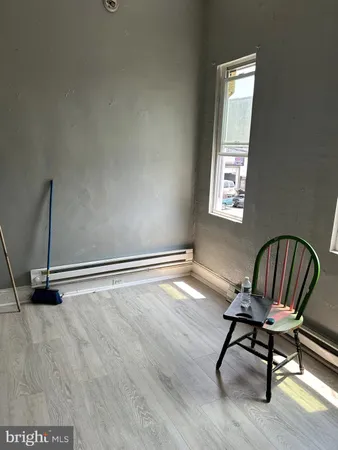 a view of a livingroom with wooden floor and a closet