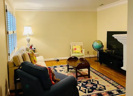 a living room with furniture and a rug