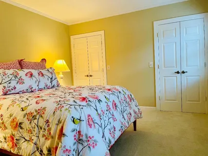 a bedroom with a bed and painting on the wall