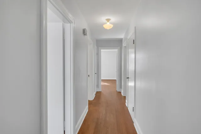 a view of a hallway with a wooden floor