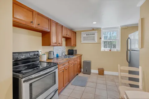 a kitchen with stainless steel appliances granite countertop a stove a sink and a refrigerator