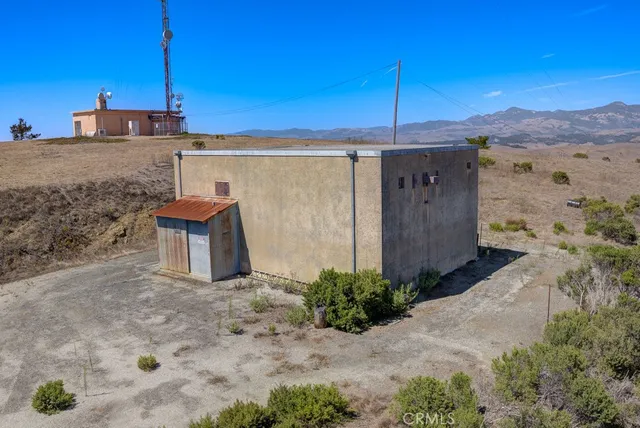 a view of a house with wooden fence