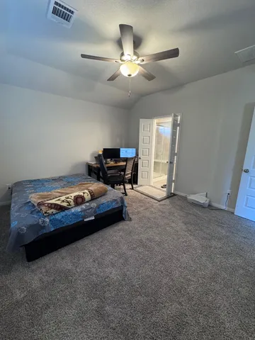 a living room with furniture and chandelier