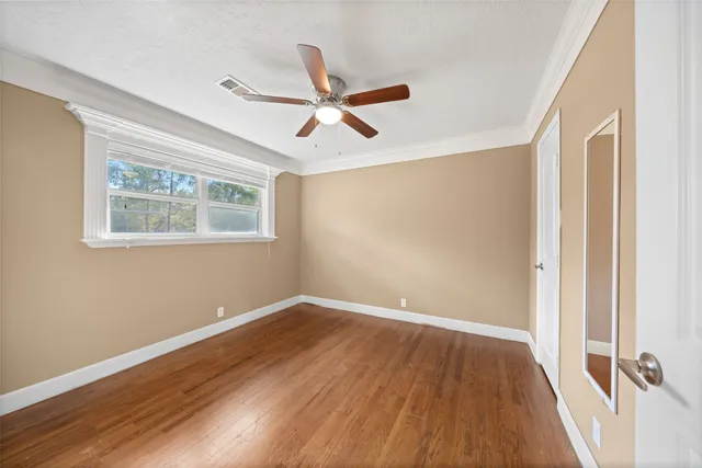 a view of room with hardwood floor and ceiling fan