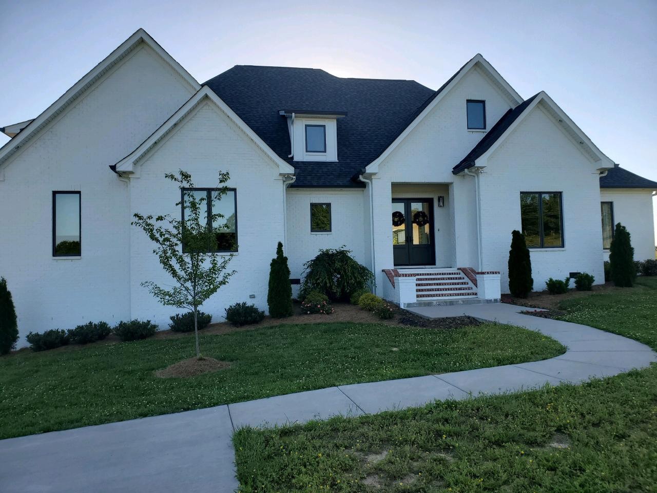 2730 Linwood Road Watertown, TN 37184 - Photo 1 of 11 a front view of a house with a garden and plants