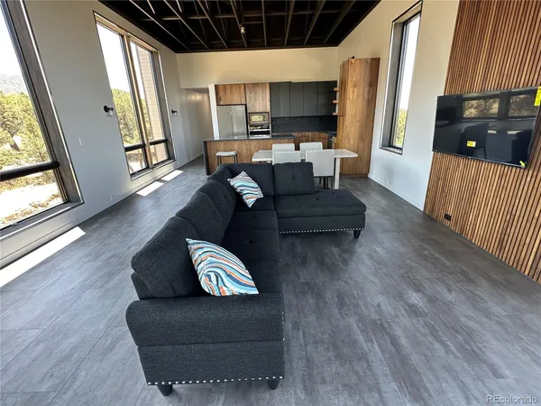 a living room with couches and a flat screen tv