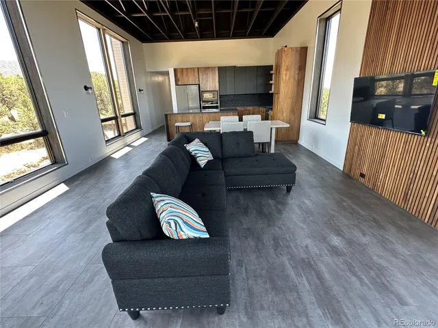 a living room with couches and a flat screen tv