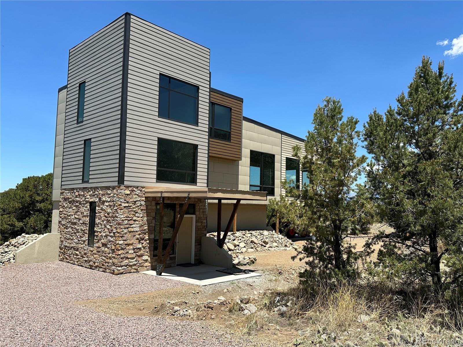 99 Cedar Ridge Road Mosca, CO 81146 - Photo 2 of 36 a front view of a house with a yard