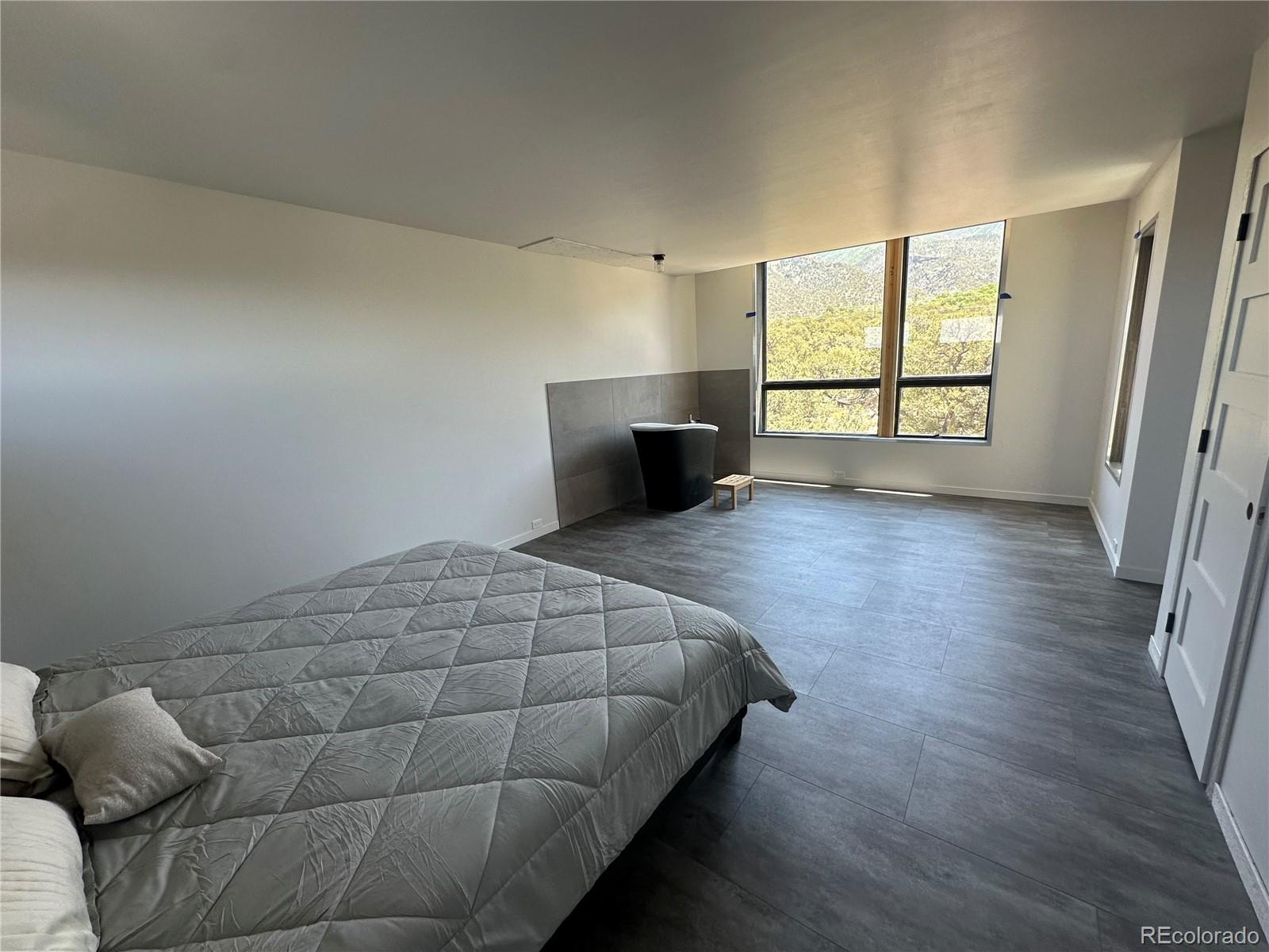 99 Cedar Ridge Road Mosca, CO 81146 - Photo 26 of 36 a bedroom with a bed and a window